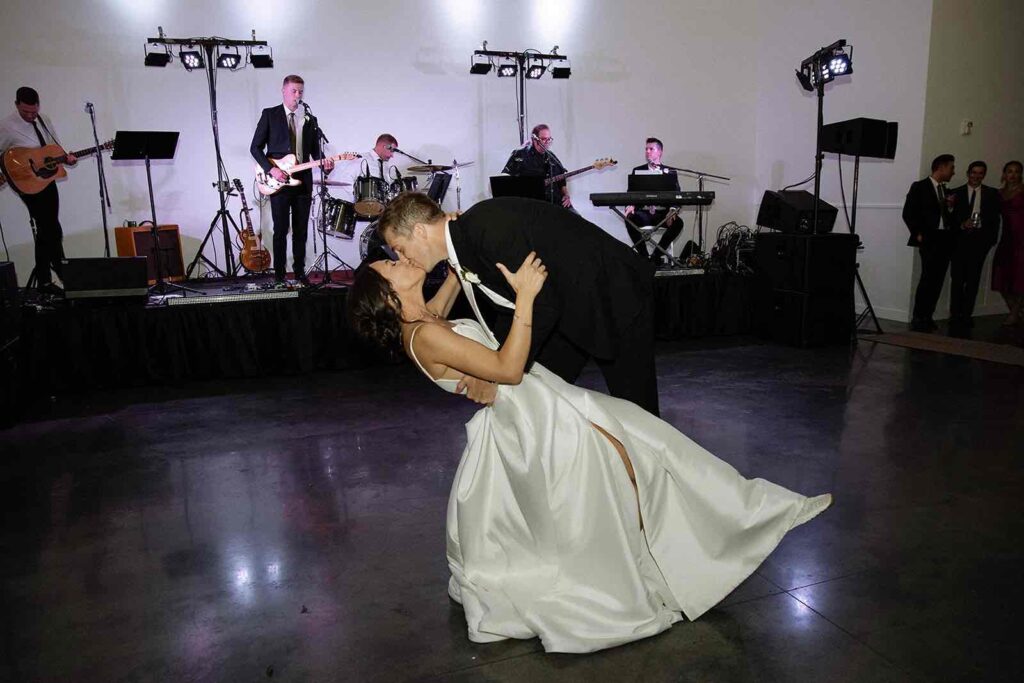 Bride and groom sharing their first dance to live band music during their wedding reception at The Pines