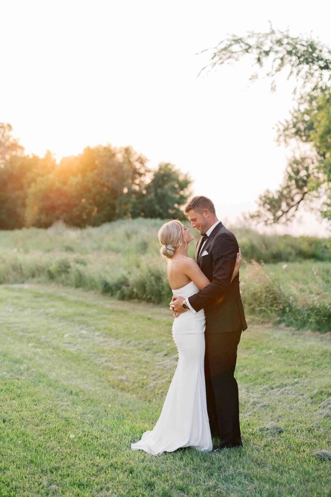 Bride and groom sharing their first dance under warm, ambient reception lighting, lost in a romantic moment at The Pines.