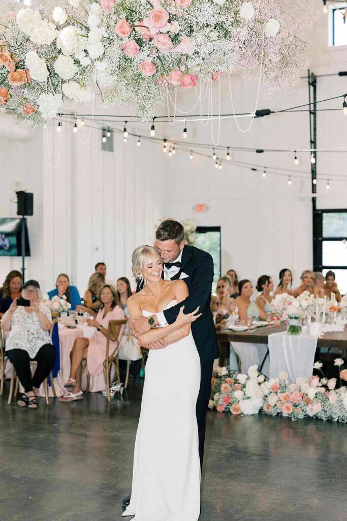 Bride joyfully celebrating at The Pines reception, with her arms raised in excitement.