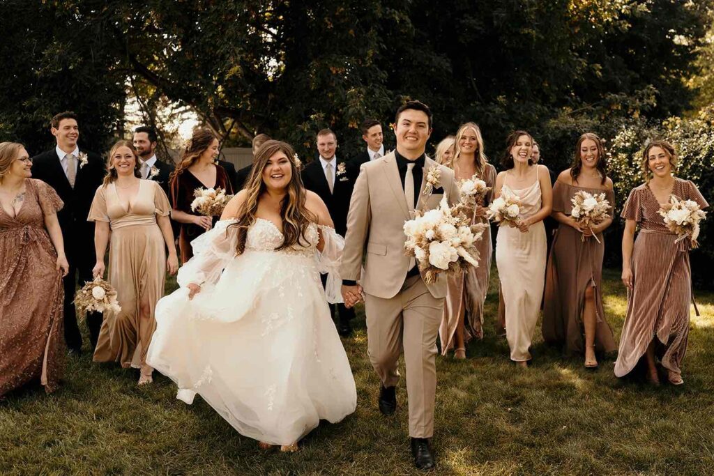 Happy bride and groom with their boho styled bridal party celebrating their special day.