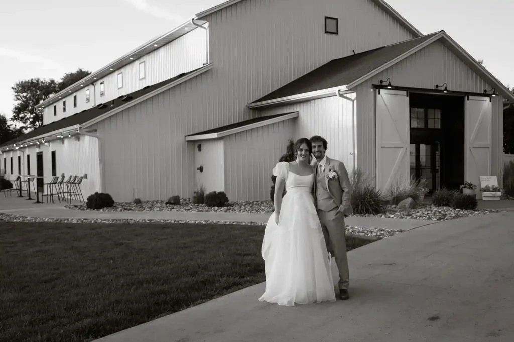 Bride and groom smiling outside The Pines White wedding venue captured at sunset