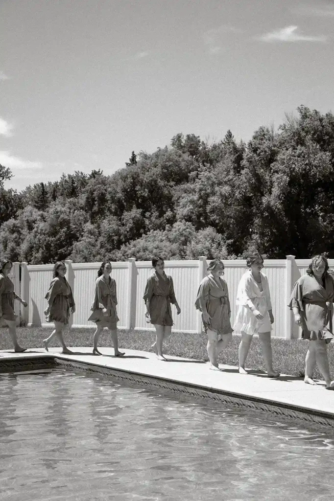bridal party walking beside pool