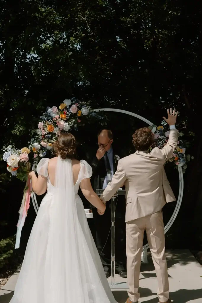 Bride and groom worshipping during outdoor ceremony